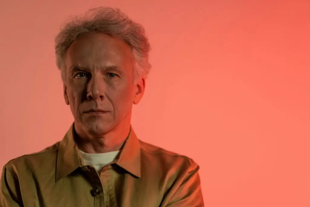Alt Text: alt="Filmmaker James Cameron, director of Avatar, looking directly at the camera in a formal studio portrait.