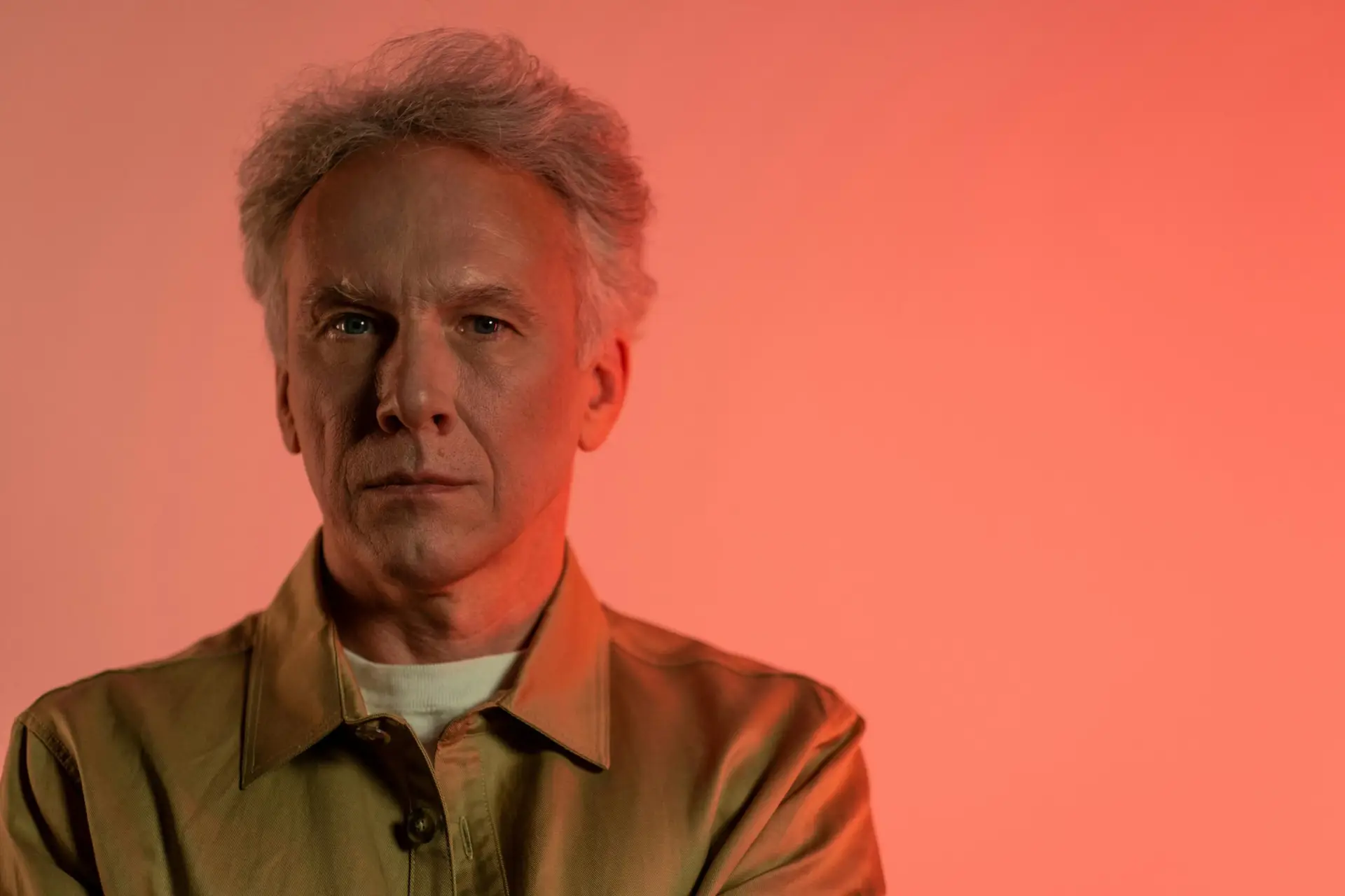 Alt Text: alt="Filmmaker James Cameron, director of Avatar, looking directly at the camera in a formal studio portrait.